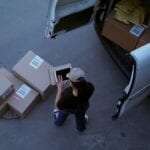 Woman counting packages on a mobile device