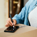 Customer giving a signature after receiving the goods