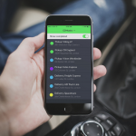 Man holding a mobile phone with open GSMtasks app